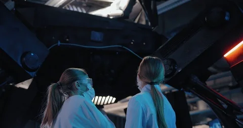 Scientists are looking at a technical setup with a robot. Huge equipment in the Stock Footage 102968064