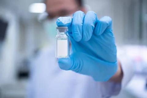 Scientists are preparing a vaccine to be placed in sterile boosters. Stock Photos