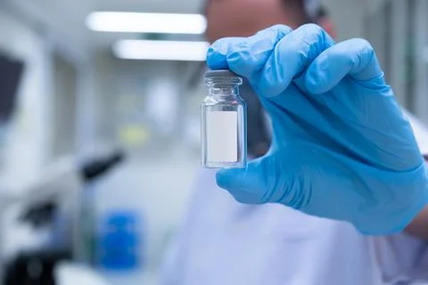 Scientists are preparing a vaccine to be placed in sterile boosters. Stock Photos