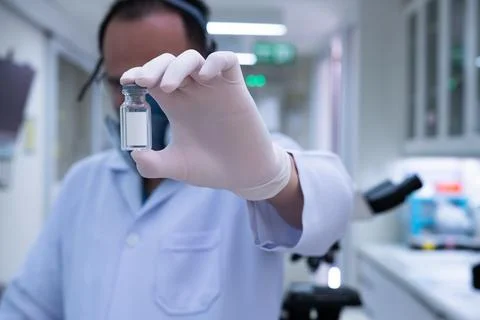 Scientists are preparing a vaccine to be placed in sterile boosters. Stock Photos