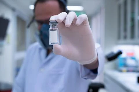 Scientists are preparing a vaccine to be placed in sterile boosters. Stock Photos