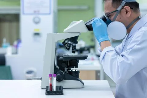 Scientists are studying research on the germs that cause COVID-19, the main c Stock Photos