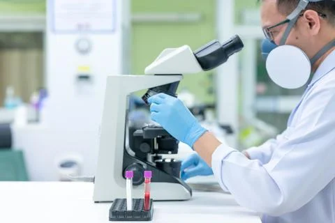 Scientists are studying research on the germs that cause COVID-19, the main c Stock Photos