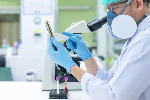 Scientists are studying research on the germs that cause COVID-19, the main c Stock Photos