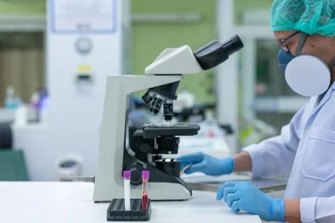 Scientists are studying research on the germs that cause COVID-19, the main c Stock Photos