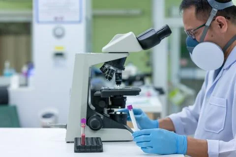 Scientists are studying research on the germs that cause COVID-19, the main c Stock Photos