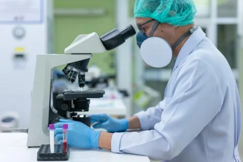 Scientists are studying research on the germs that cause COVID-19, the main c Stock Photos