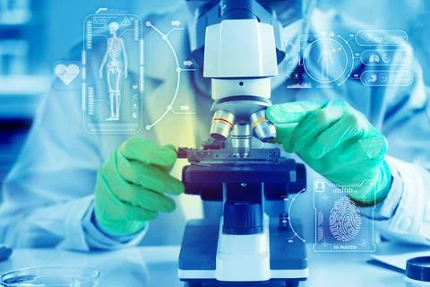 Scientists are using a microscope to test for viruses. or bacteria in the lab Stock Photos