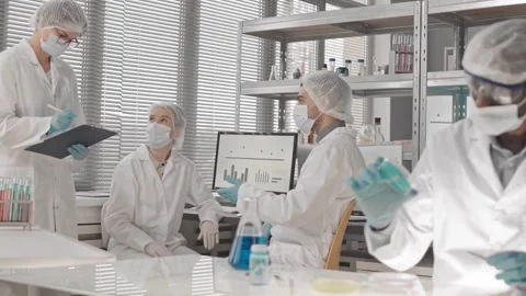 Scientists Collaborating in Modern Laboratory During Daytime Stock Footage 320090916