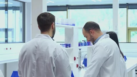 Scientists collaborating on research project in modern laboratory Stock Footage 296885552
