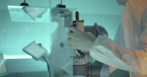 Scientists configure robot arm in laboratory Stock Footage 232902708