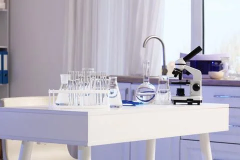 Scientists desk with microscope and water samples in laboratory Фото