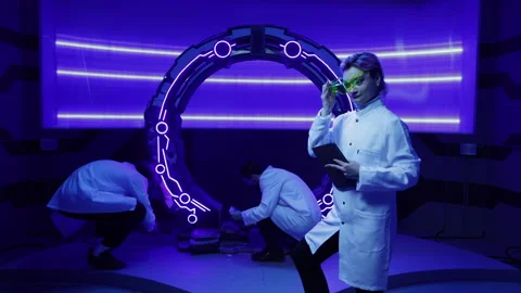 Scientists developing new researching tests in futuristic, neon-ish interior Stock Footage 242195889
