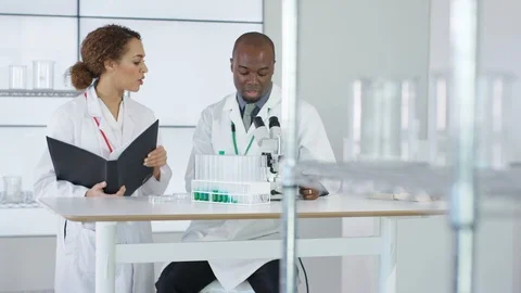Scientists discuss during research and other make a test in background Stock Footage 107589157