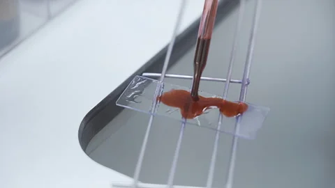 Scientists drop brown solution close up Stock Footage 247403493