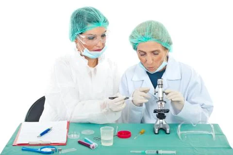 Scientists females using microscope Stock Photos
