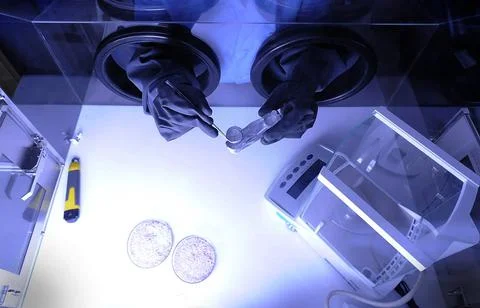 Scientist's hand in the incubator. Elements of this image furnished by NASA. Stock Photos