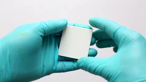A scientist’s hand showing a small TLC plate cut from a larger sheet. Stock Footage 321971032