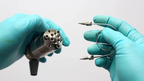 Scientist's hands in gloves installing a 100 µL sample loop on an HPLC valve Stock Footage 322070630