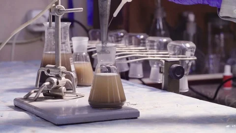 Scientist's hands taking out agitator from flask Stock Footage 87951724