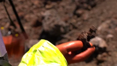 Scientists holding rock in mars simulated landscape Stock Footage 93533235