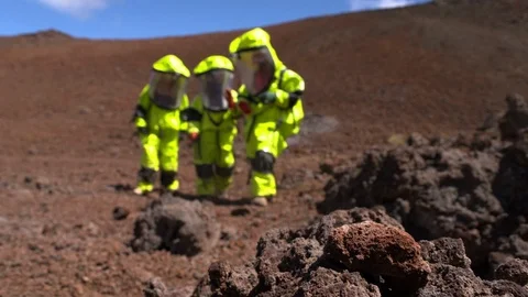 Scientists holding rock in mars simulated landscape Stock Footage 93533351