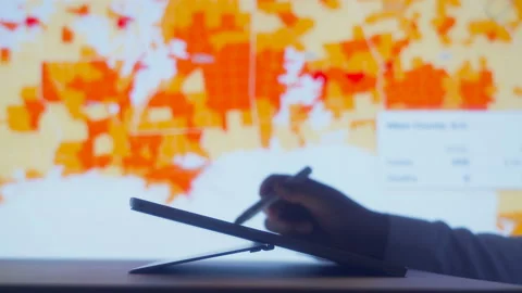 Scientists look at Covid-19 map of the USA on computer Stock Footage 134754726