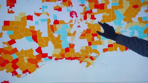 Scientists look at Covid-19 map of the USA on computer Stock Footage 134823296