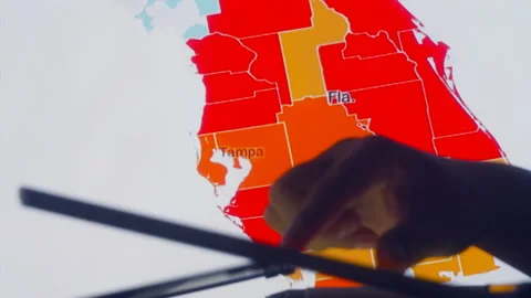 Scientists look at Covid-19 map of the USA on computer Stock Footage 134824155
