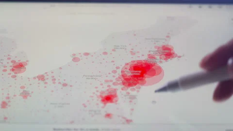 Scientists look at Covid-19 map of the USA on computer Stock Footage 134852618