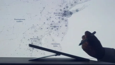 Scientists look at Covid-19 map of the USA on computer Stock Footage 135289033