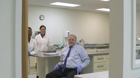 Scientists looking at camera in a laboratory Stock Footage 77078882