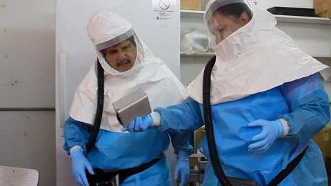 Scientists manipulating microbe pathogen contaminated material Stock Footage 105114269