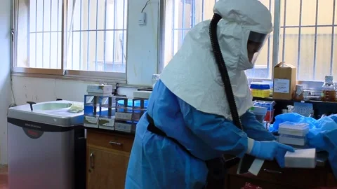 Scientists manipulating microbe pathogen contaminated material Stock Footage 171395648