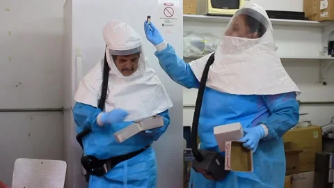 Scientists manipulating pathogen contaminated material Stock Footage 160582320