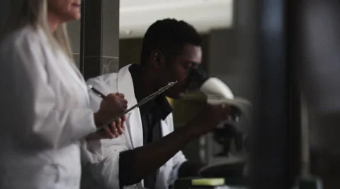 Scientists In Microscope Stock Footage 62944527