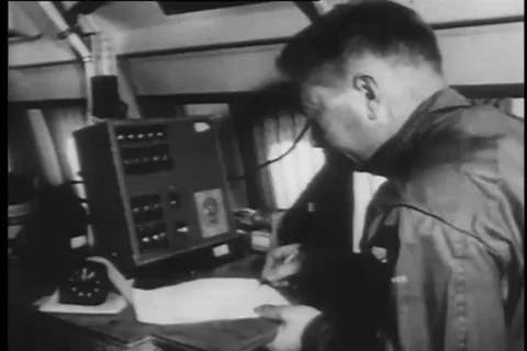 Scientists operate controls and write down notes of the study - 1958 Video stock 99592138