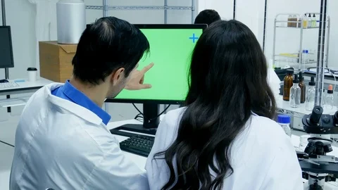 Scientists or chemists using computer for work. Green screen marking on desktop Stock Footage 92675311