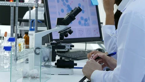 Scientists or chemists using microscopes and other technologies. Video stock 92153353