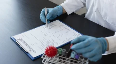 Scientists or physicians analyze the blood sample in vitro to prepare a vacci Stock Photos