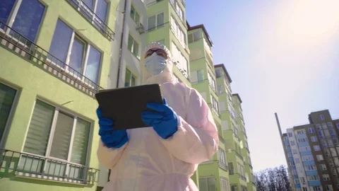 Scientists in Protective Suit in the Residential Complex Using Tablet Computer Vidéo 126817827