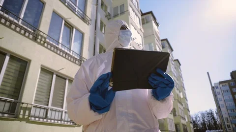 Scientists in Protective Suit in the Residential Complex Using Tablet Computer. Vidéo 126985174