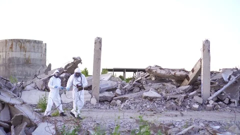 Scientists in protective suits and masks and apersonal ionizing radiation Stock Footage 110346863