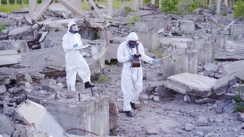 Scientists in protective suits and masks and a personal ionizing radiation Stock Footage 110748428