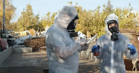 Scientists in protective suits are arguing with each other, impossible breathe Stock Footage 119051877