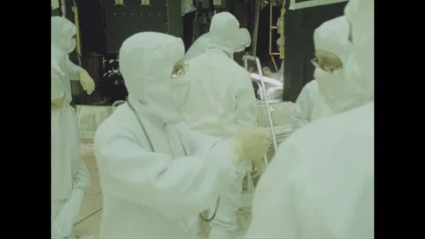Scientists in protective work wear interact with each other - 1988 Stock Footage 104333674