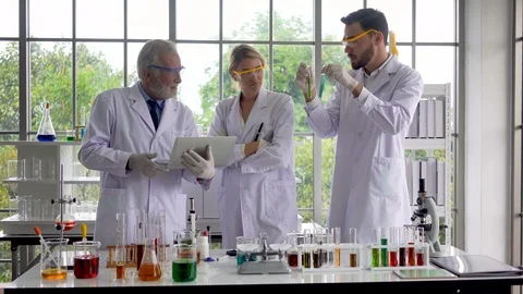 Scientists  research and test green liquid chemistry in a test tube made Stock Footage 106539841