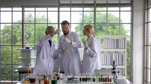 Scientists  research and test green liquid chemistry in a test tube made Stock Footage 106539908