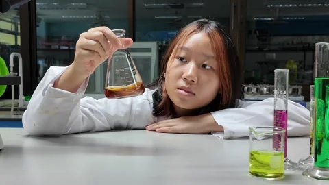 Scientists shake the solution in a Erlenmeyer flask Stock Footage 276174452