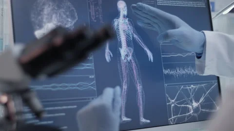 Scientists studying brainwave scanning and human skeleton. Close up on hands Video stock 149800733